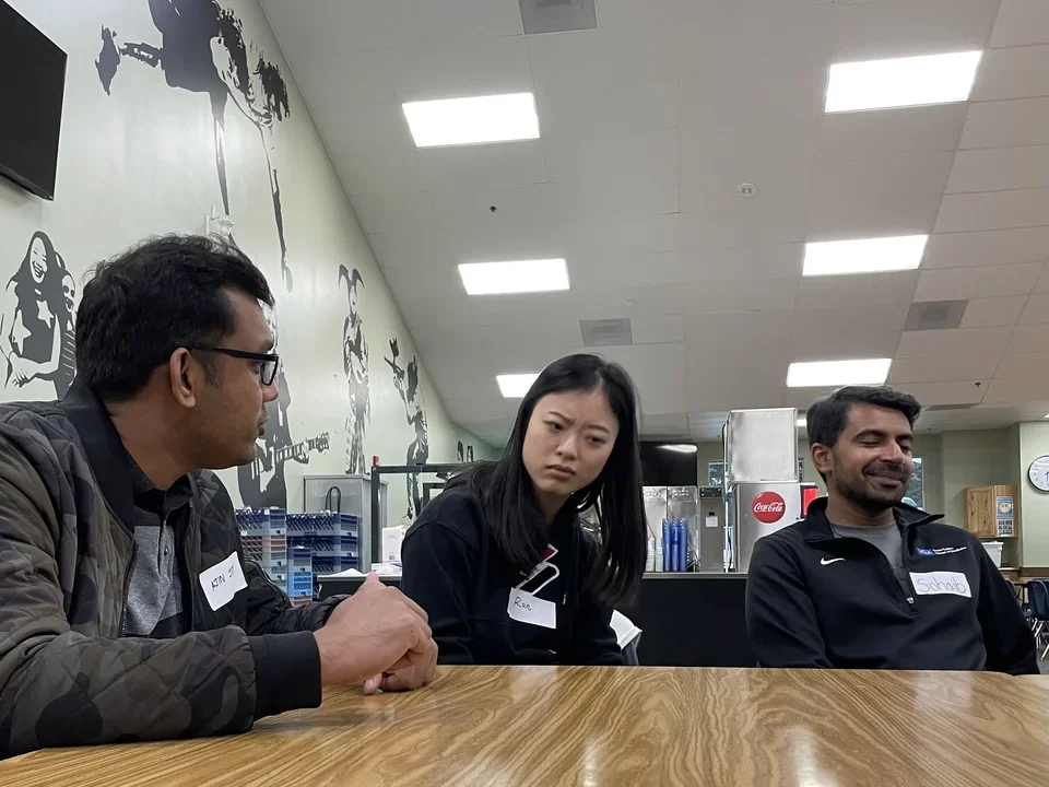 Three lab members in cafeteria